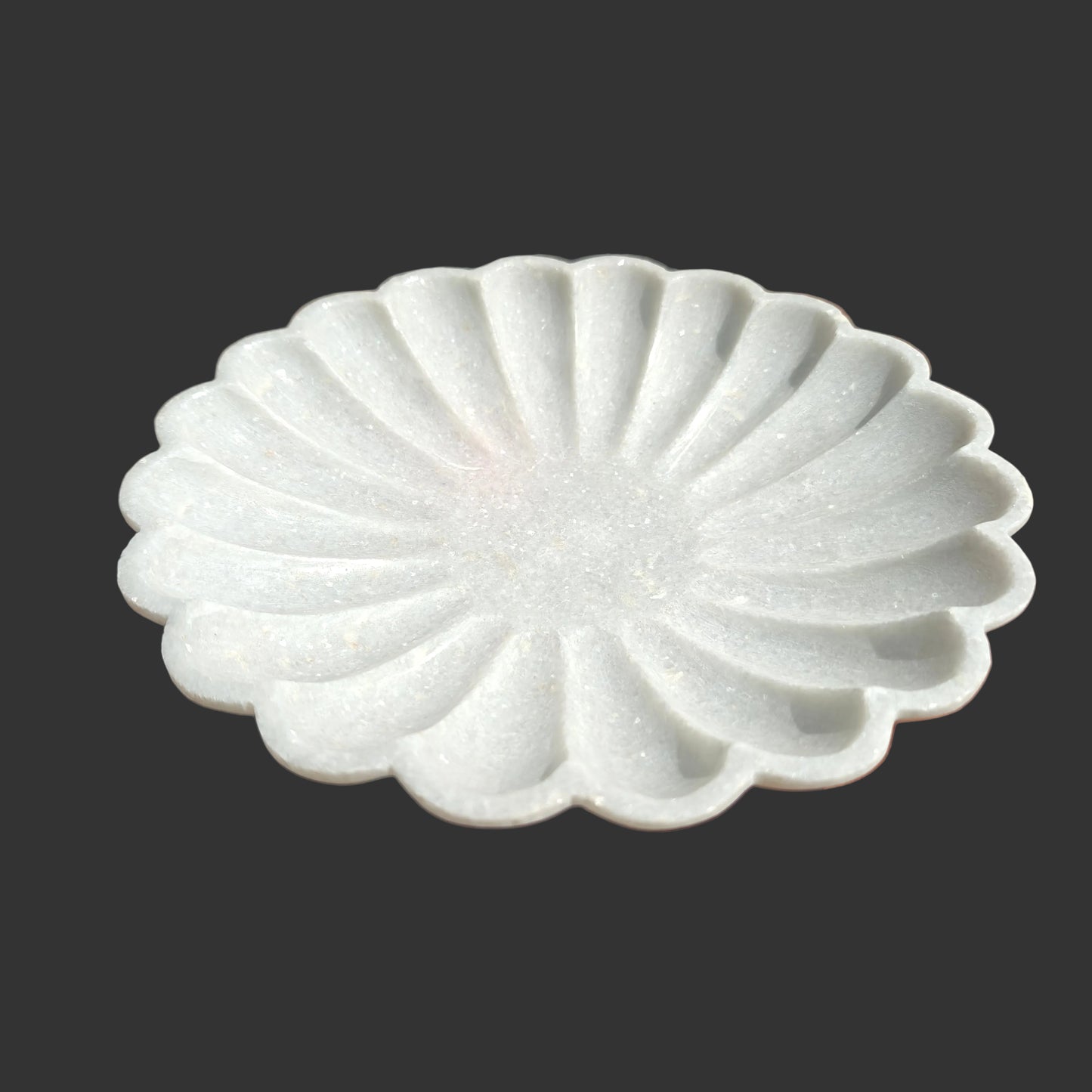White marble scalloped plate close up hand-carved ridges Rajasthan