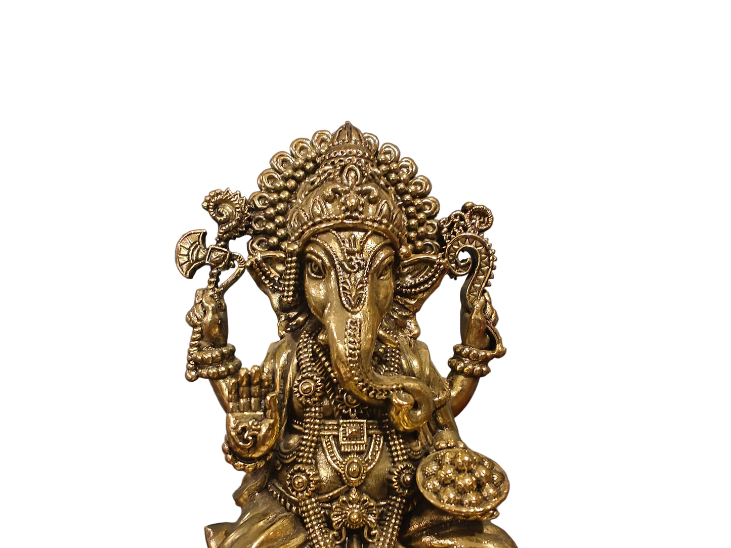 Close-up of brass Ganesha idol showing crown, jewellery and facial details