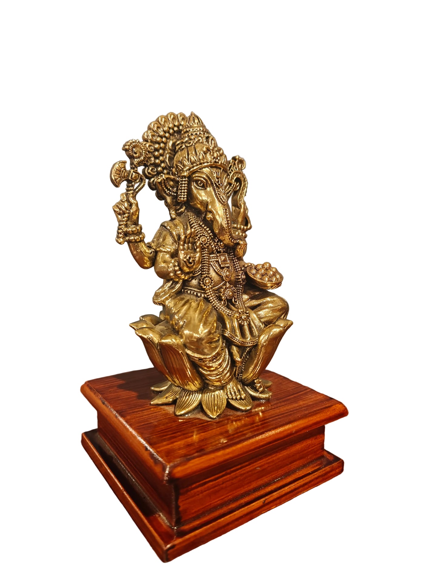 Angled view of brass Ganesha idol on carved decorative base