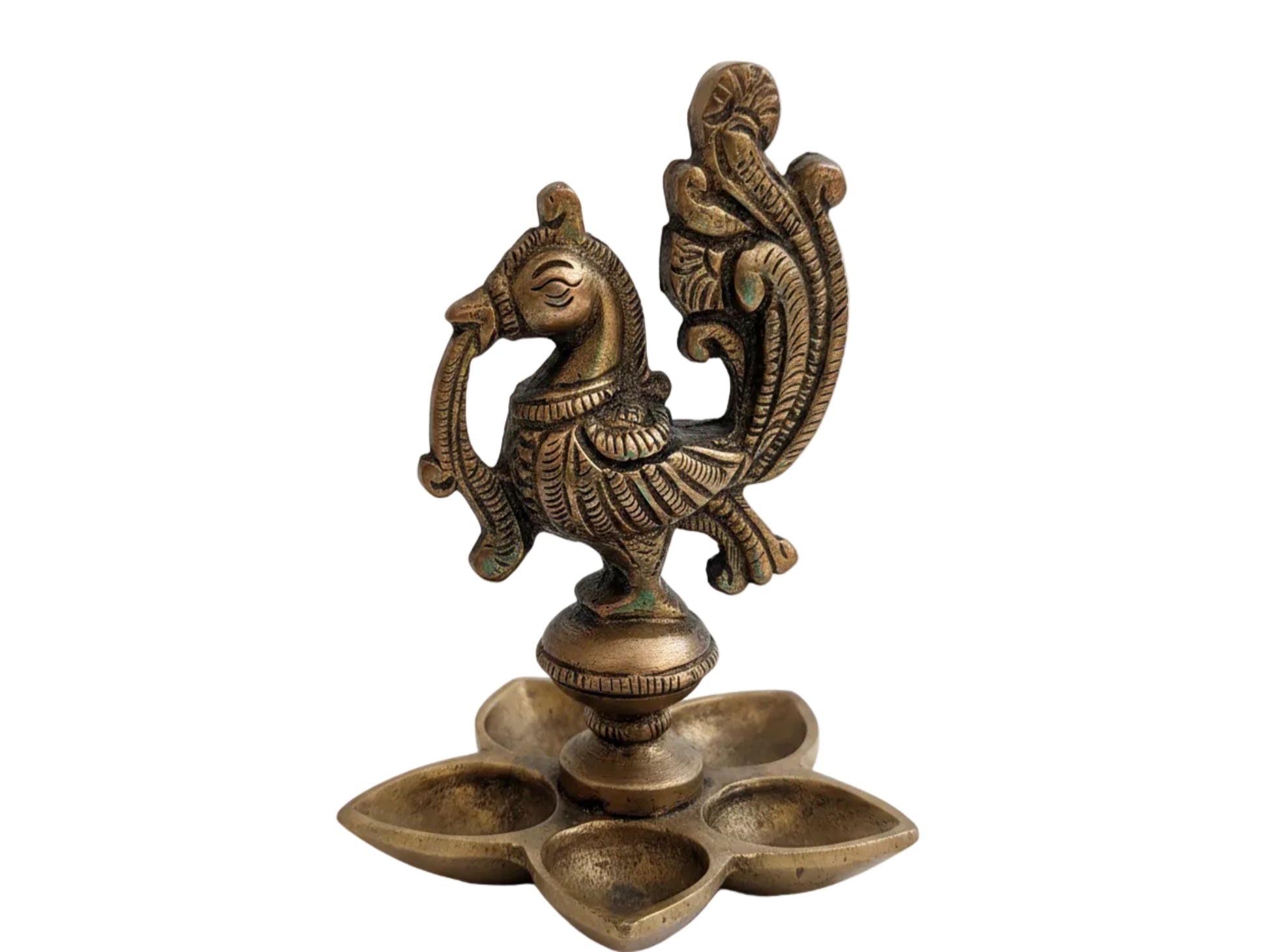 Close-up of handcrafted brass peacock figurine with detailed tail feathers and fine relief work