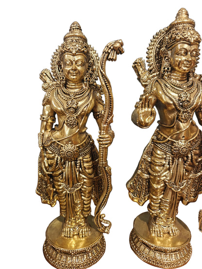 Angled view of brass Ram Darbar idol set displayed on wooden surface