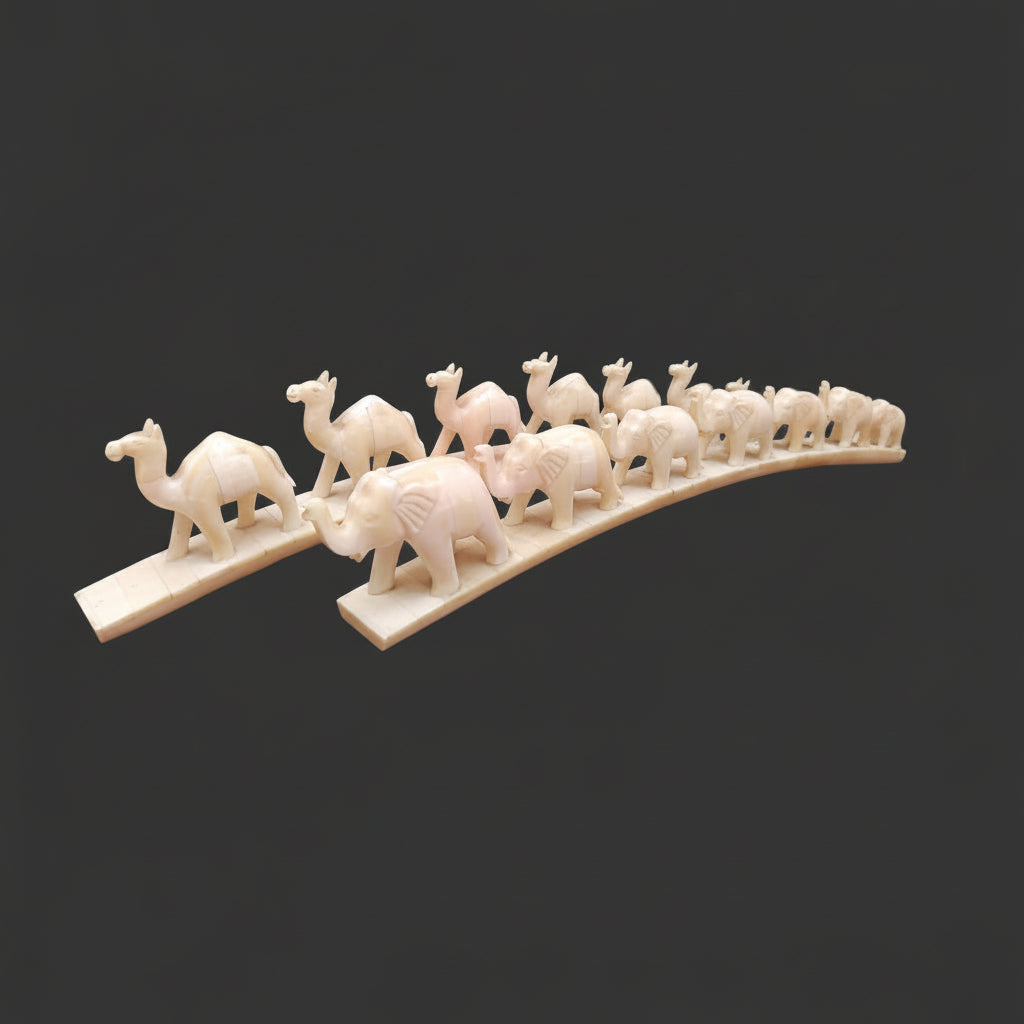 Set of carved bone animal parades with elephant and camel designs on arched bases
