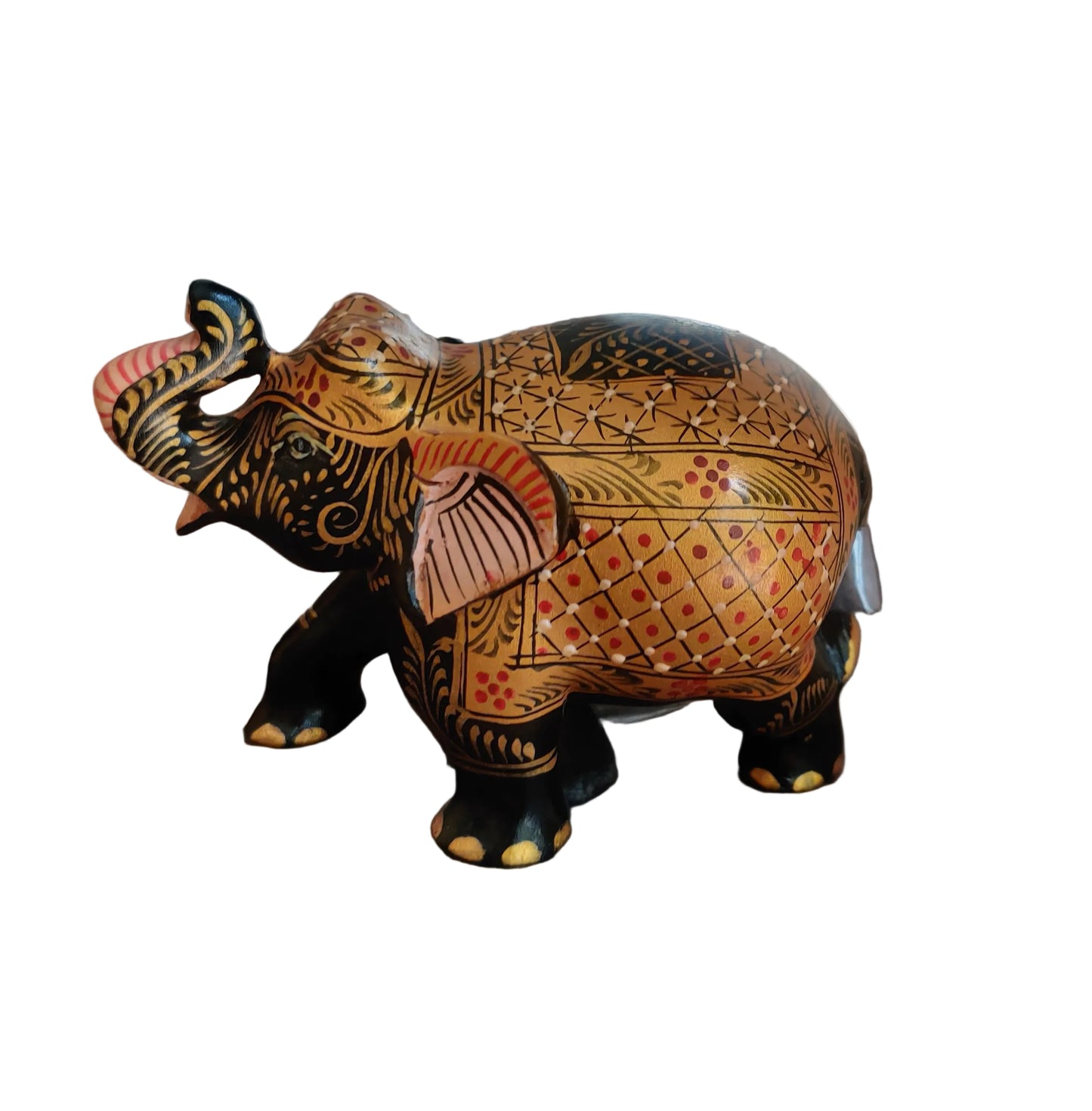 Close up of intricate gold, black and red folk art motifs on wooden elephant figurine