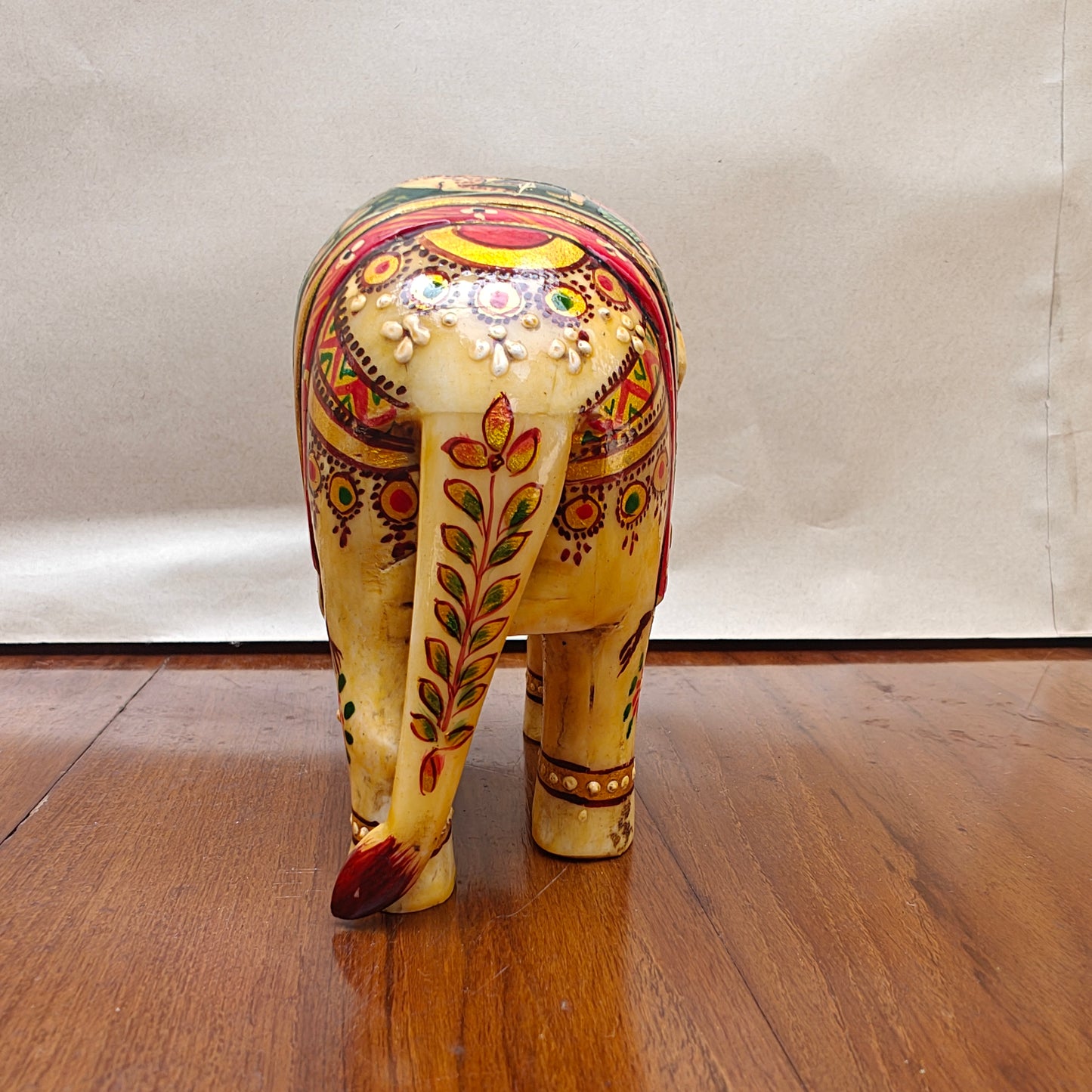 Back view of light-toned handpainted bone elephant home decor figurine
