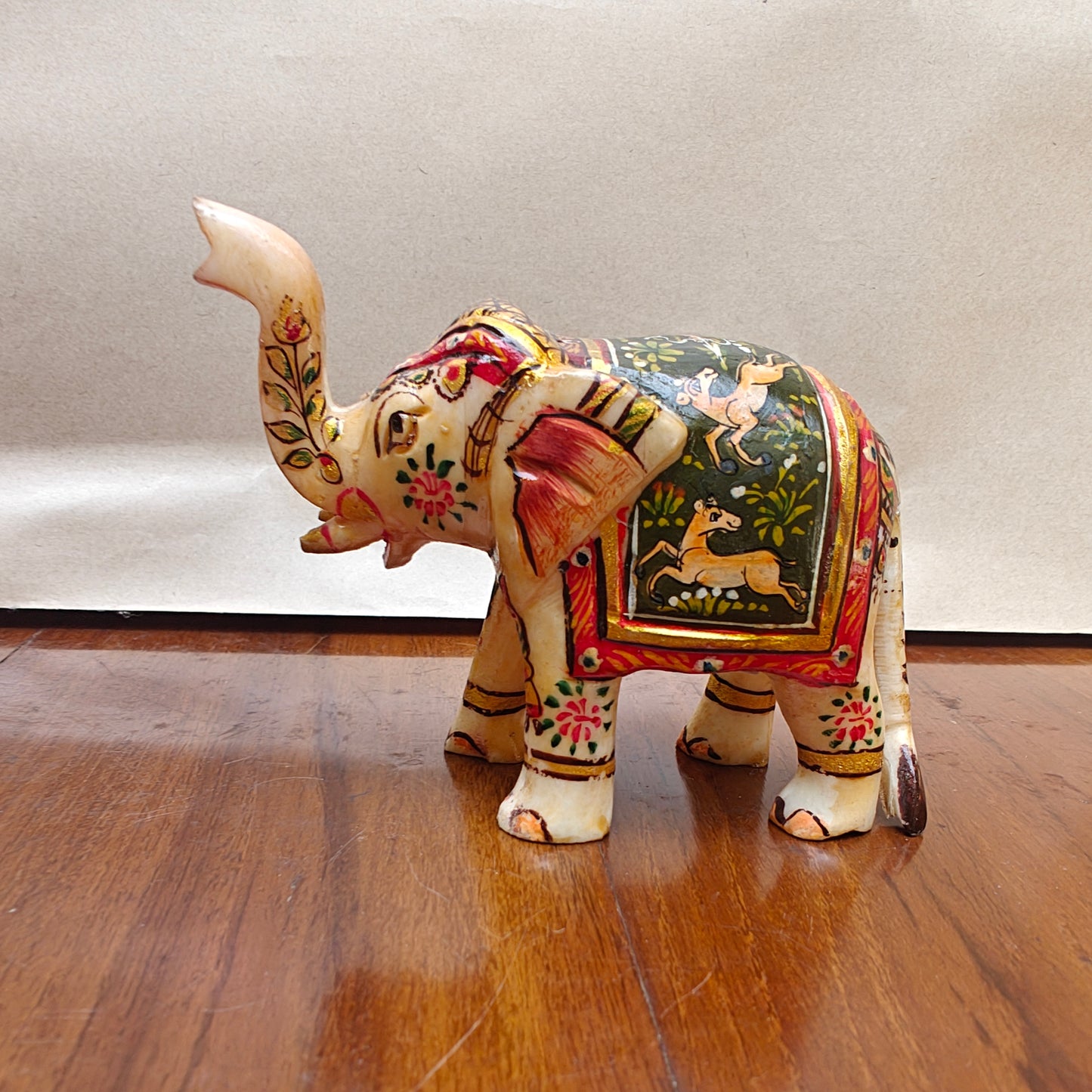 Back view of light-toned handpainted mini bone elephant home decor figurine