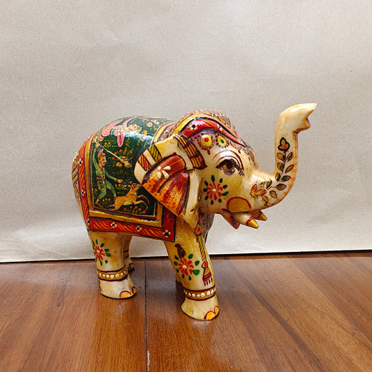Handpainted miniature bone elephant figurine with storytelling artwork – front side view