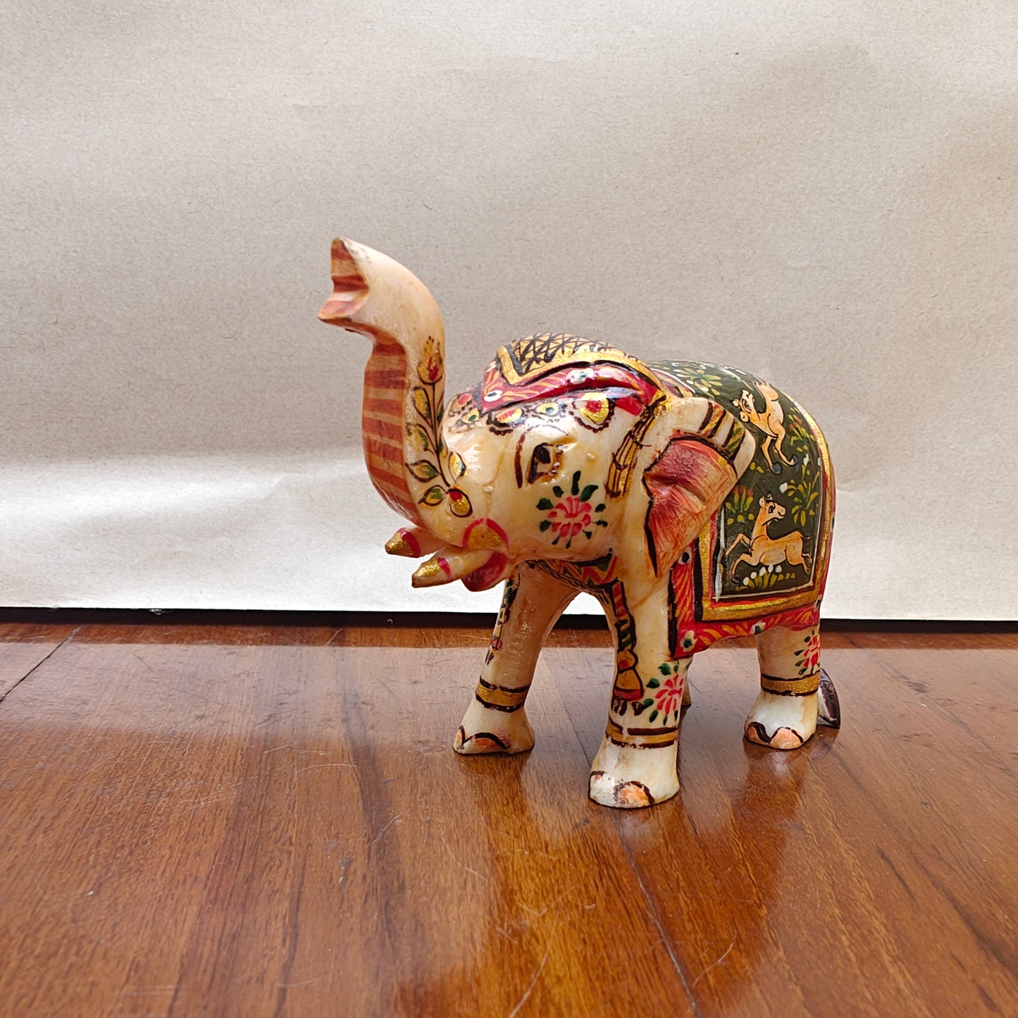 Side profile of handpainted mini bone elephant decor showing detailed animal painting