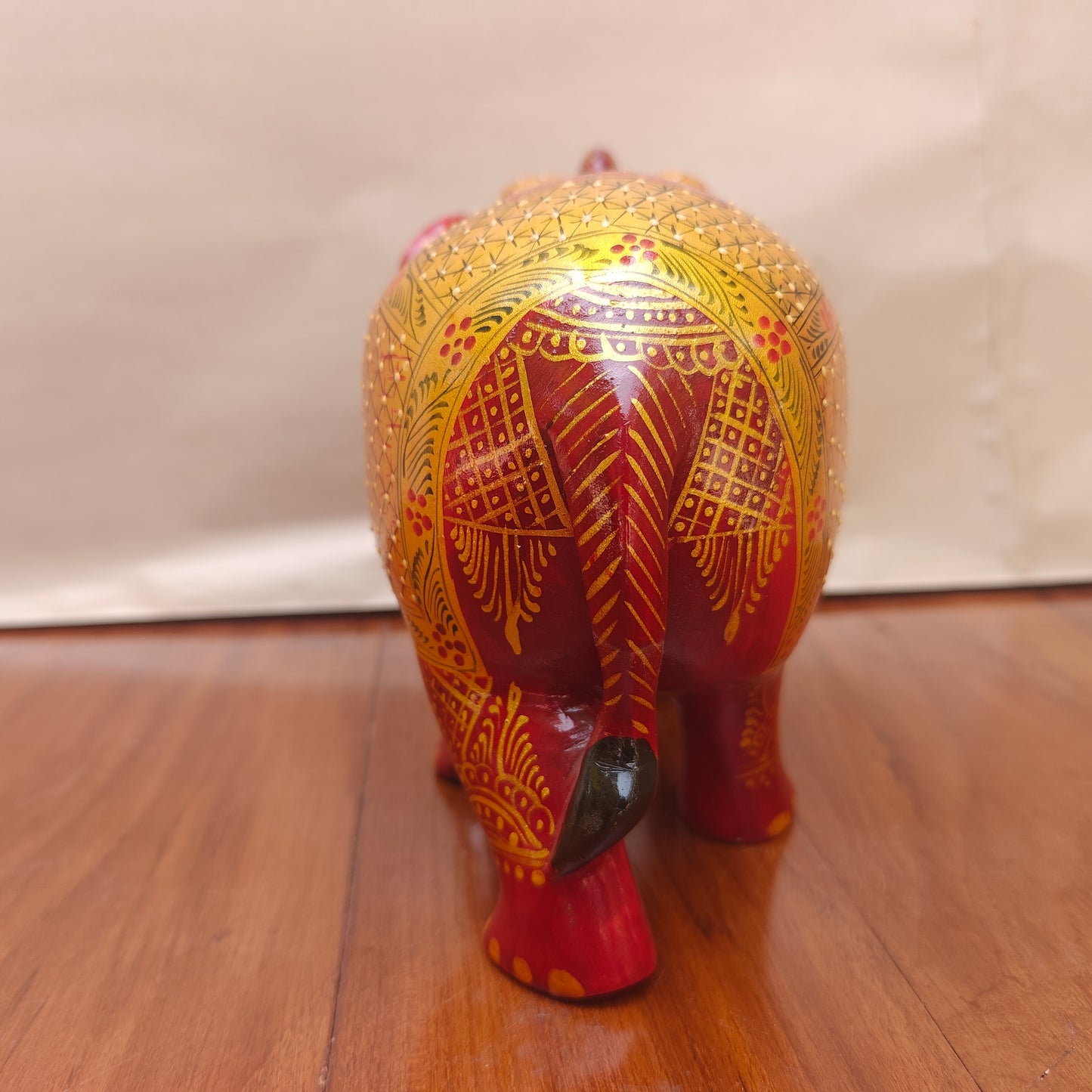 Back view of red and yellow handpainted elephant home decor figurine