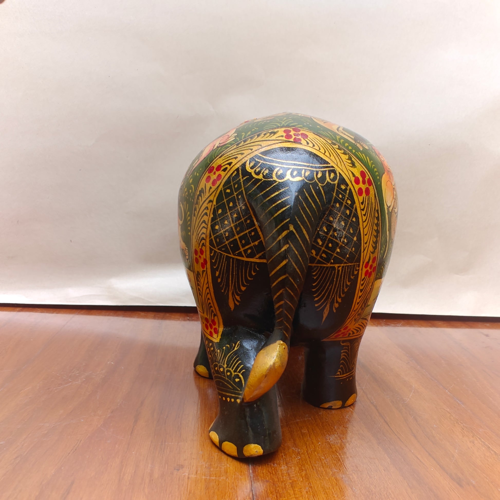 Back view of black and multicolour storytelling elephant home decor figurine