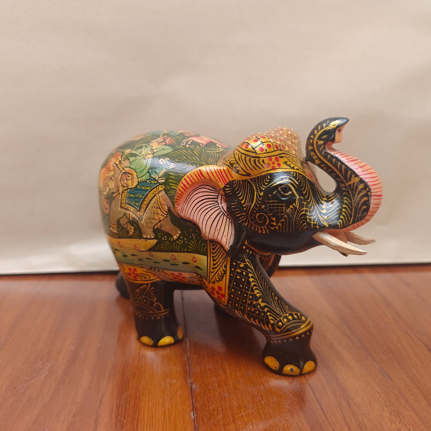 Handpainted storytelling elephant figurine with miniature-style artwork – front side view