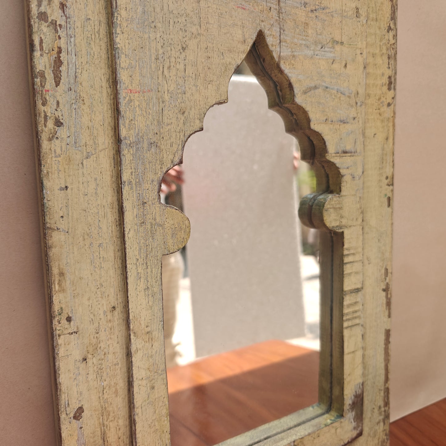 Close up of carved mihrab arch opening on Jharokha mirror frame