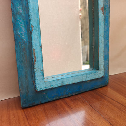 Close up of distressed blue paint finish and wood grain on Jharokha mirror frame base