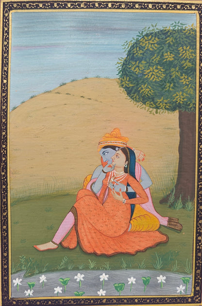 Angled view of Radha Krishna under the tree miniature painting on paper showing pink border