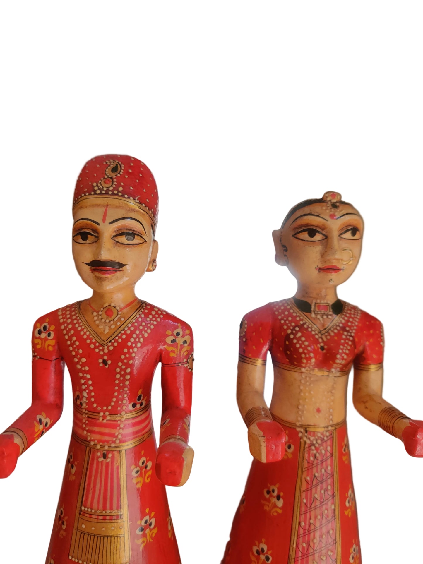 Close up of hand-painted floral and dot work detail on Rajasthani wooden figurines