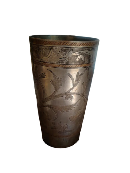 Hand-etched floral and vine motifs on antique Indian brass tumbler