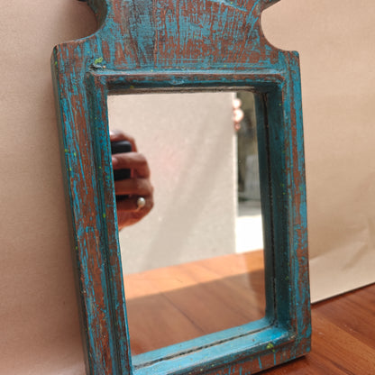 Scalloped crown detail of distressed blue wood mirror