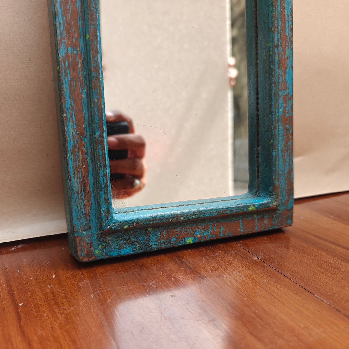 Vintage blue crown-top mirror styled on a console table