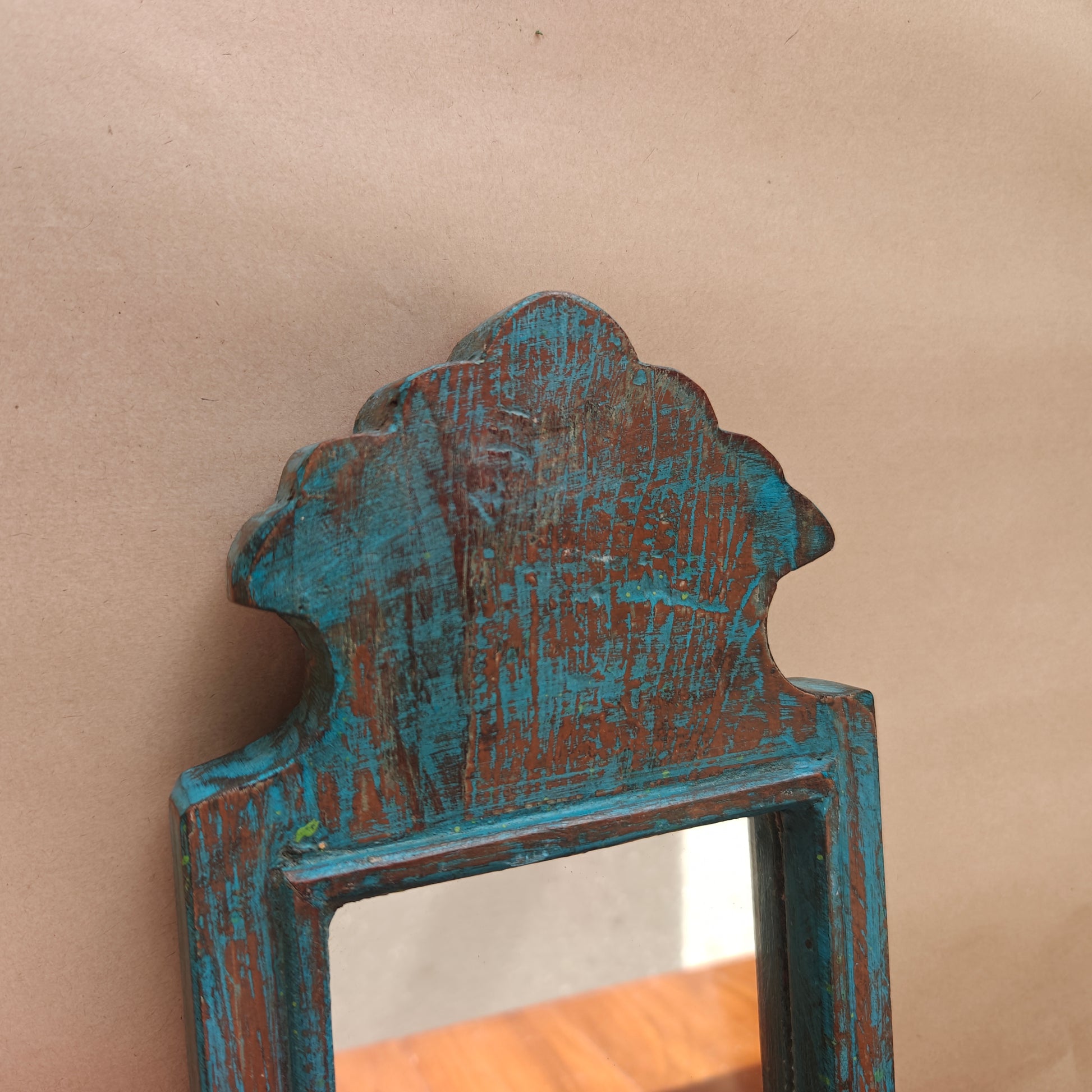 Side profile of vintage blue crown-top mirror showing frame depth