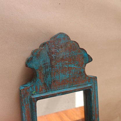 Side profile of vintage blue crown-top mirror showing frame depth