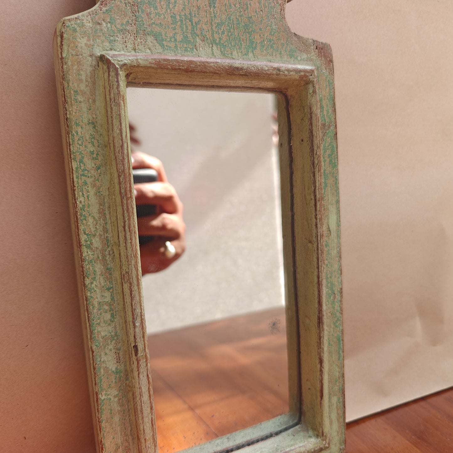 Tall pointed spire crown detail of distressed mint wood mirror