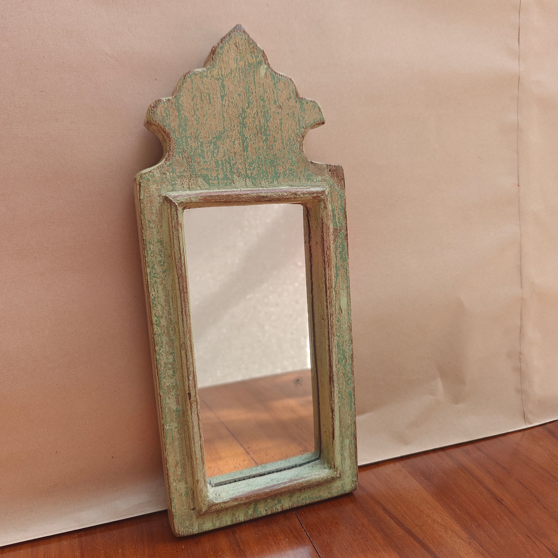 Close-up of weathered mint finish showing tan wood undertone