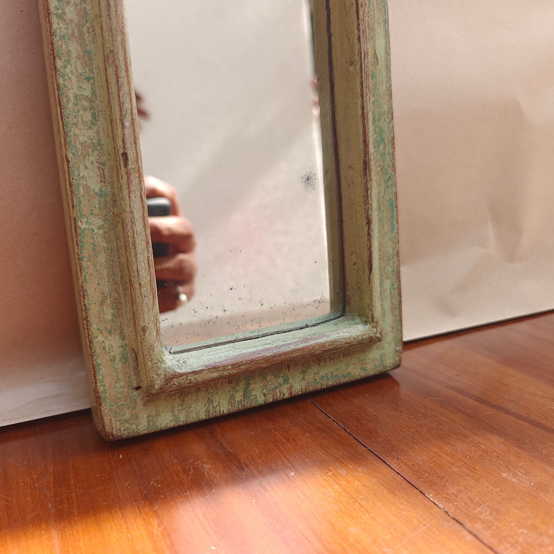 Vintage mint crown-top mirror styled on a console table
