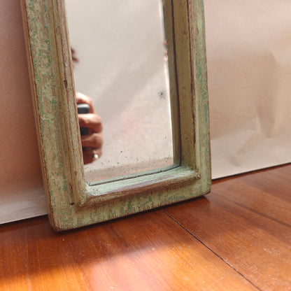 Vintage mint crown-top mirror styled on a console table