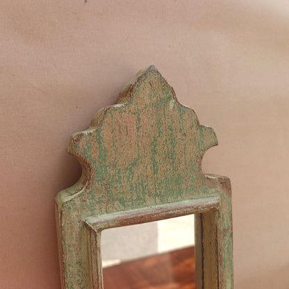 Side profile of vintage mint crown-top mirror showing frame depth