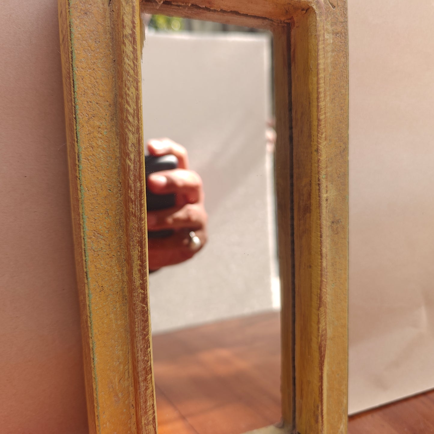 Scalloped crown detail of distressed mustard wood mirror