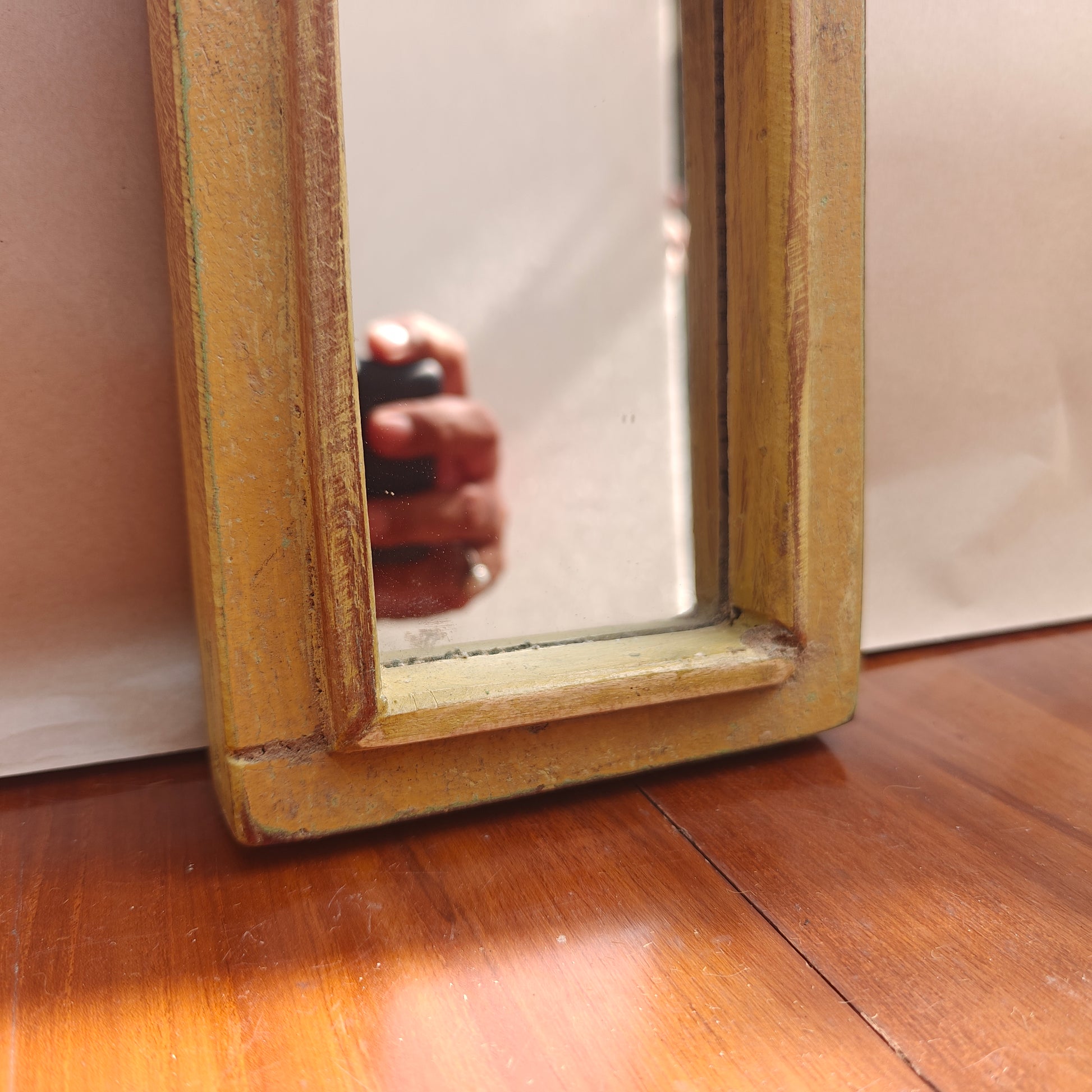 Vintage mustard crown-top mirror styled on a console table