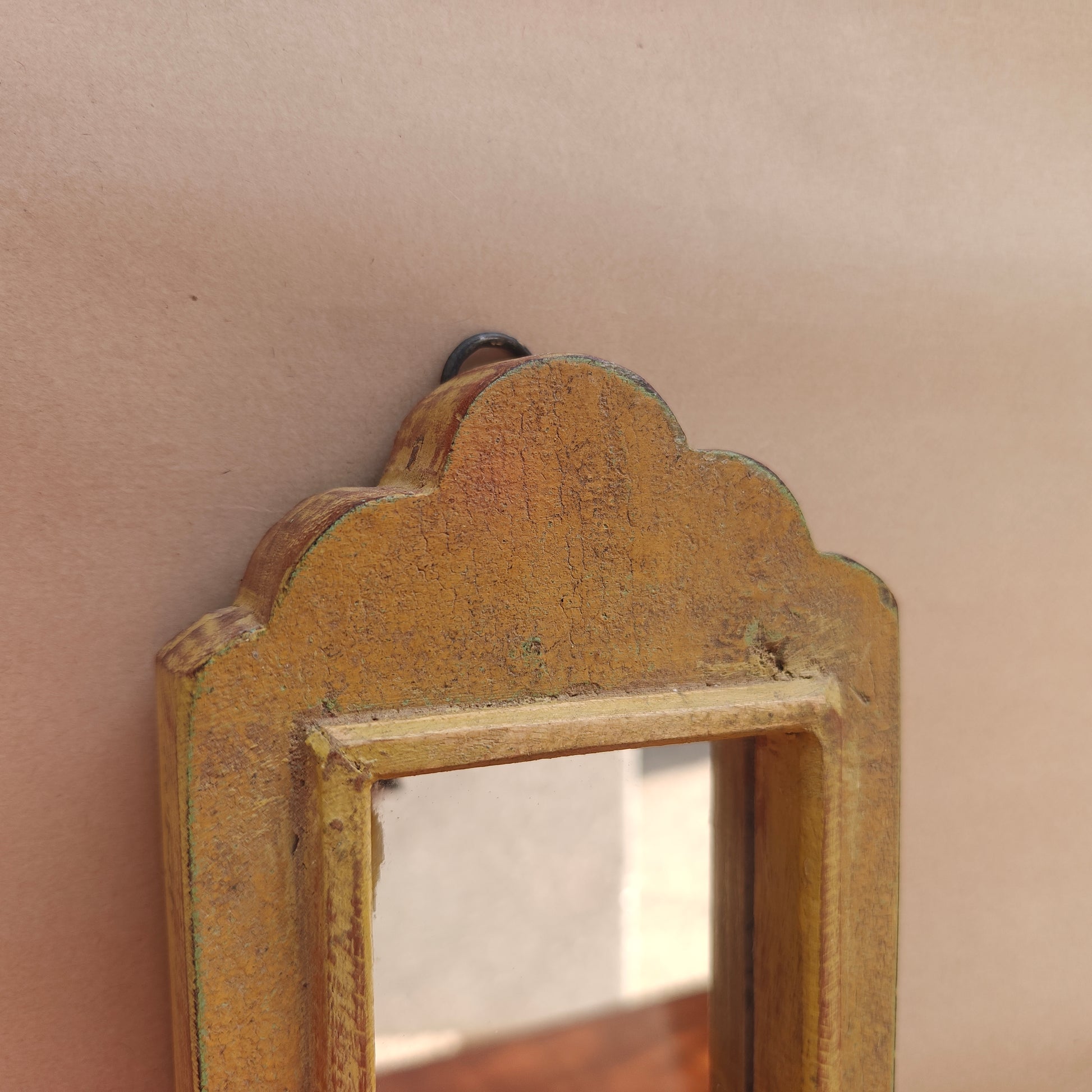 Side profile of vintage mustard crown-top mirror showing frame depth