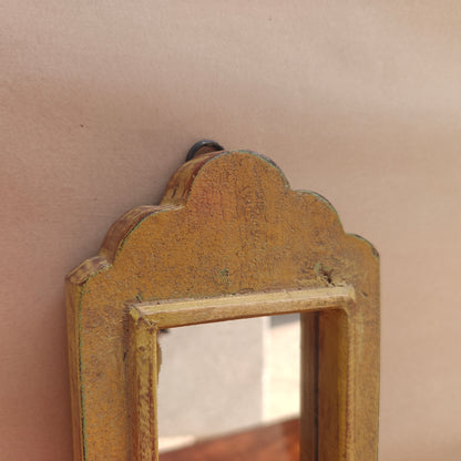 Side profile of vintage mustard crown-top mirror showing frame depth