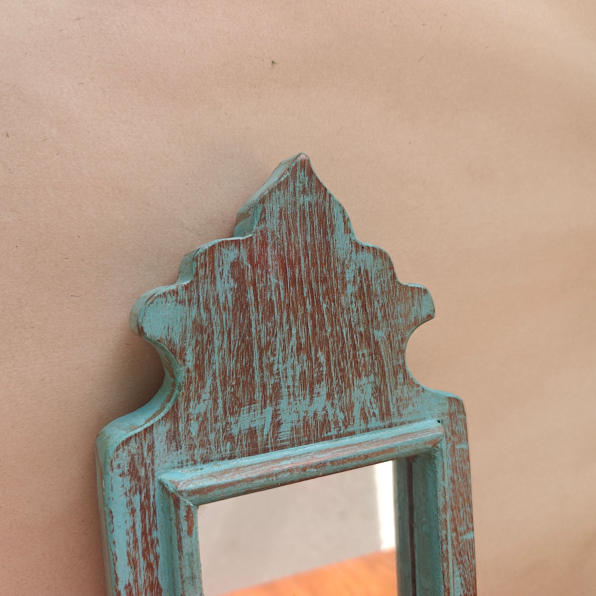 Side profile of vintage teal crown-top mirror showing frame depth
