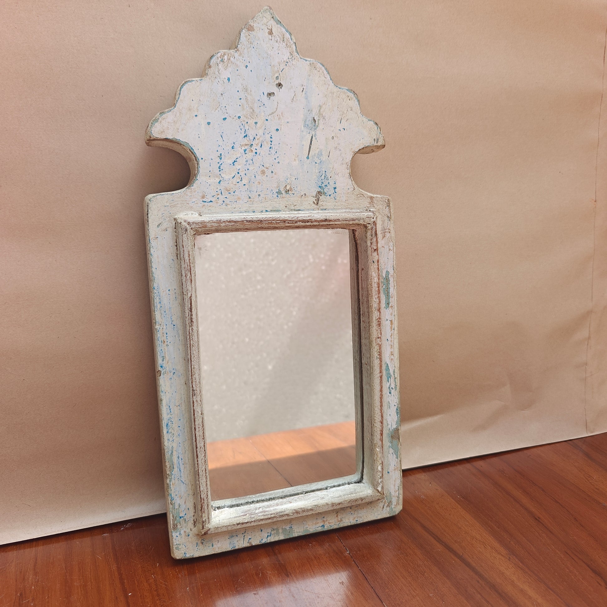 Close-up of weathered white paint finish showing blue undertone