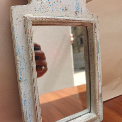 Vintage white crown-top mirror styled on a console table