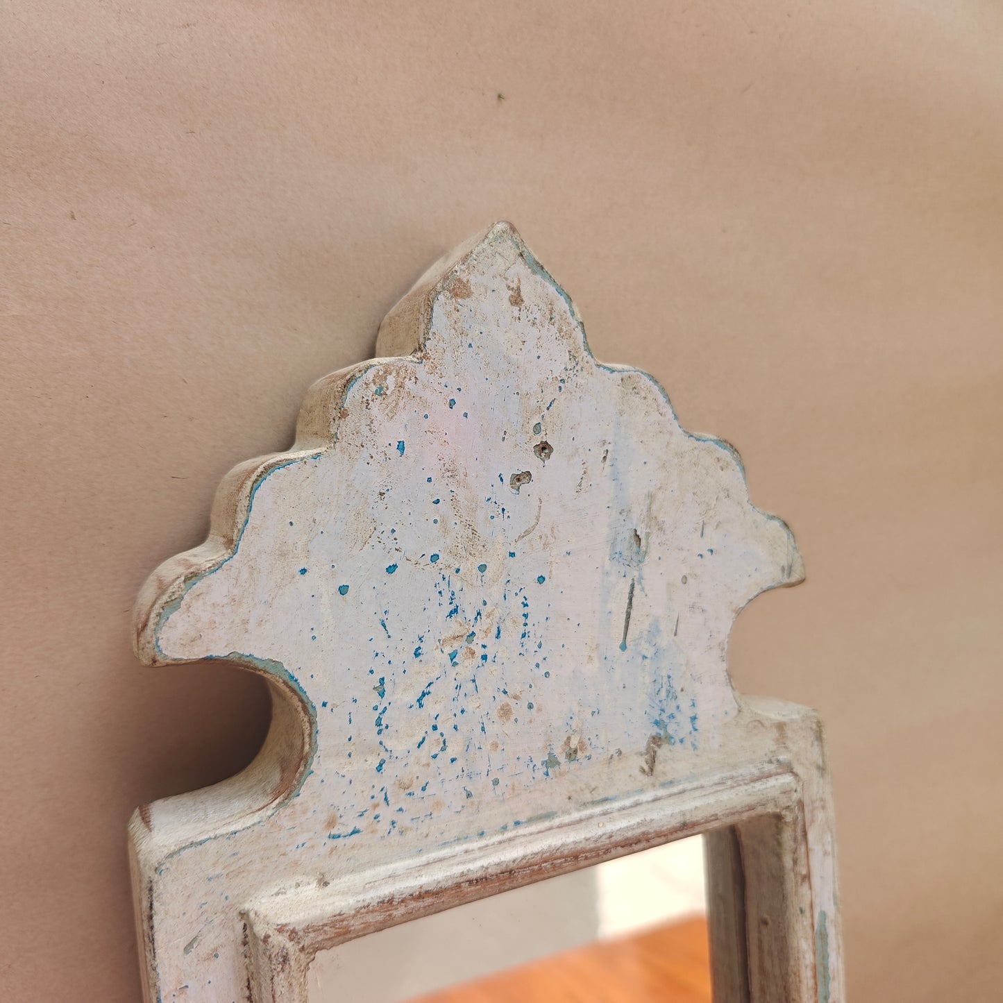 Side profile of vintage white crown-top mirror showing frame depth