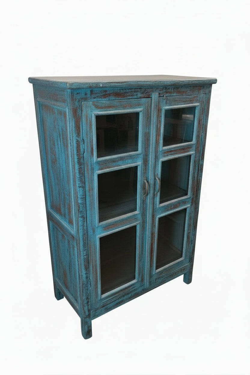 Antique Indian peacock blue painted glass display cabinet — three-quarter angle view showing bold distressed finish

