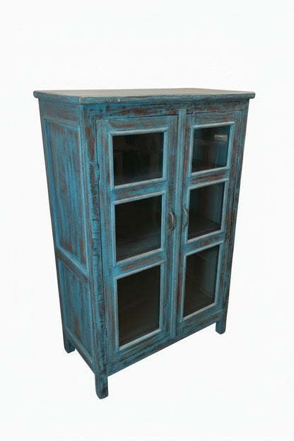 Antique Indian peacock blue painted glass display cabinet — three-quarter angle view showing bold distressed finish

