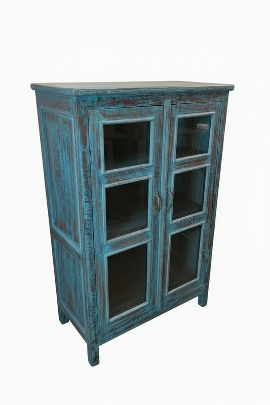 Antique Indian peacock blue painted glass display cabinet — three-quarter angle view showing bold distressed finish

