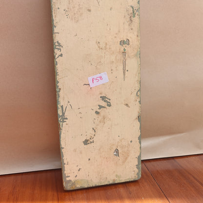 Vintage distressed sage green mirror reflecting room interior
