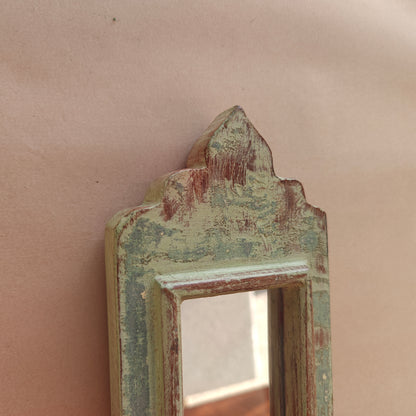 Side profile of narrow vintage sage green mirror showing frame depth