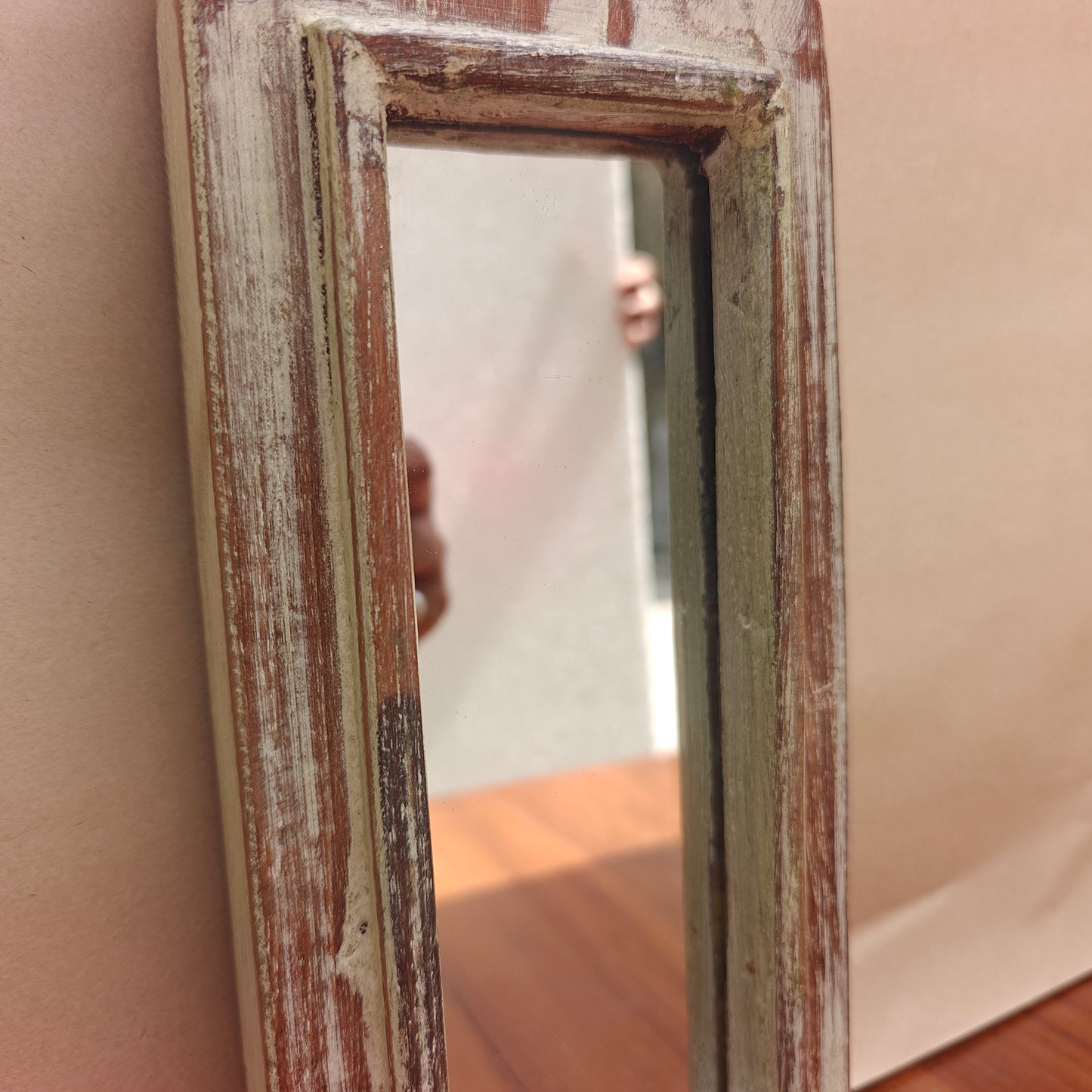 Tall pointed spire crown detail of distressed whitewash mirror
