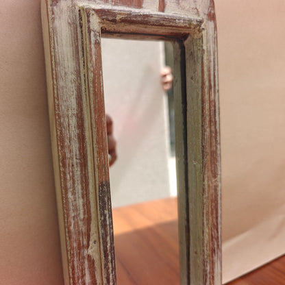 Tall pointed spire crown detail of distressed whitewash mirror