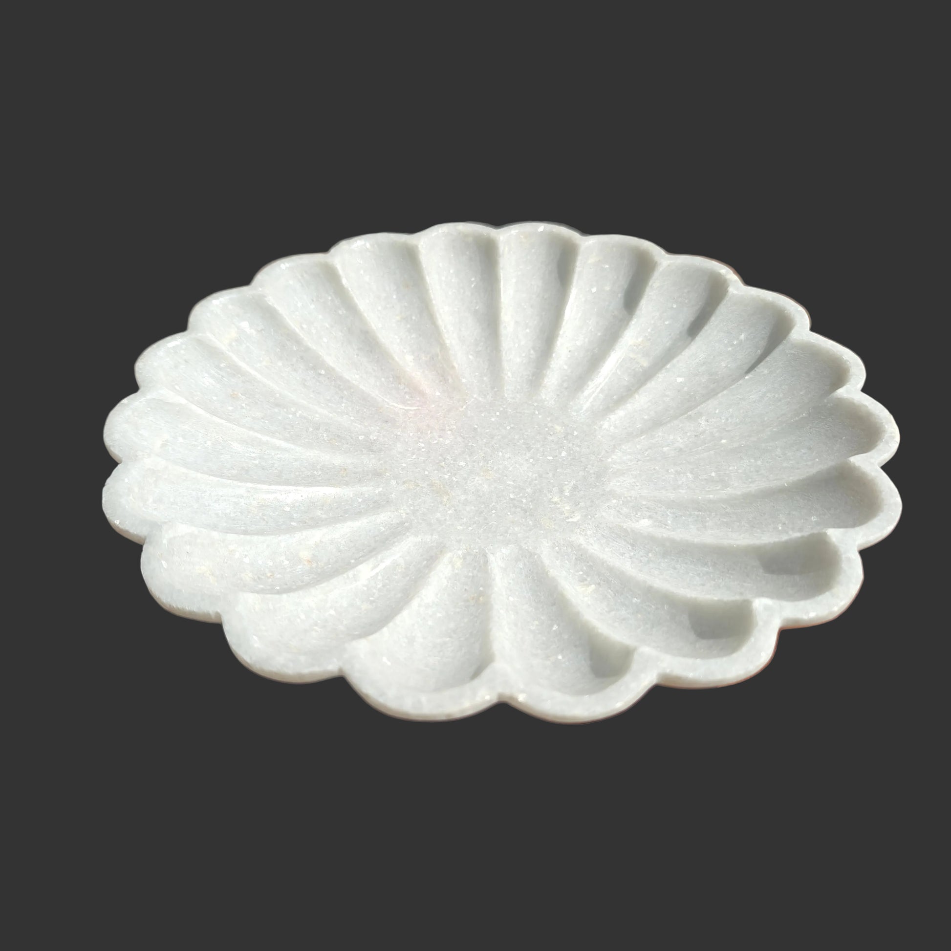 White marble scalloped plate close up hand-carved ridges Rajasthan
